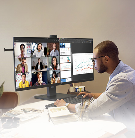 Man is working with Philips docking monitor